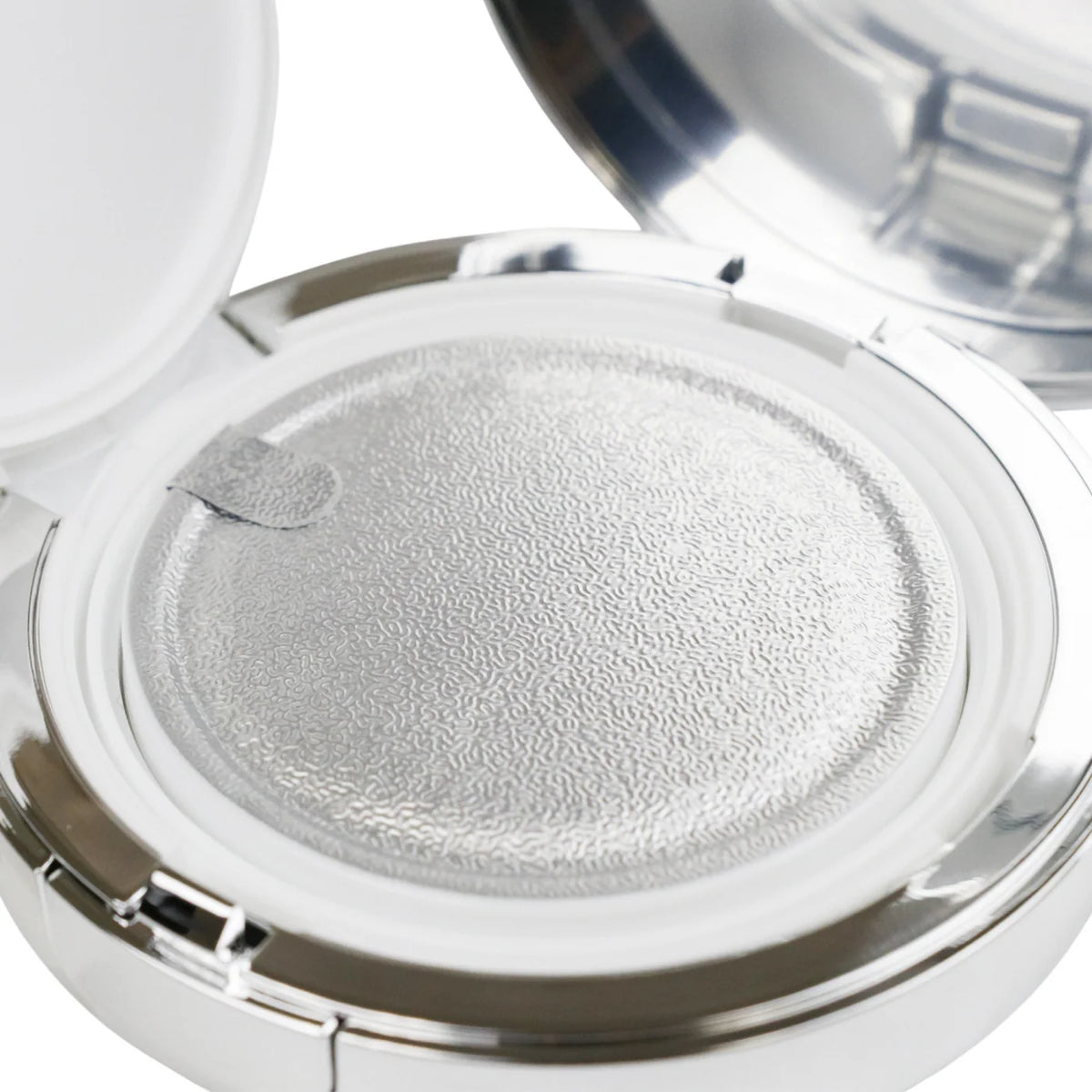 Compact powder with a silver lid on a white background